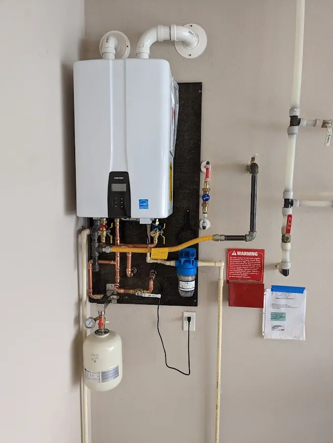 Professional plumber installing copper piping in a Xenia home